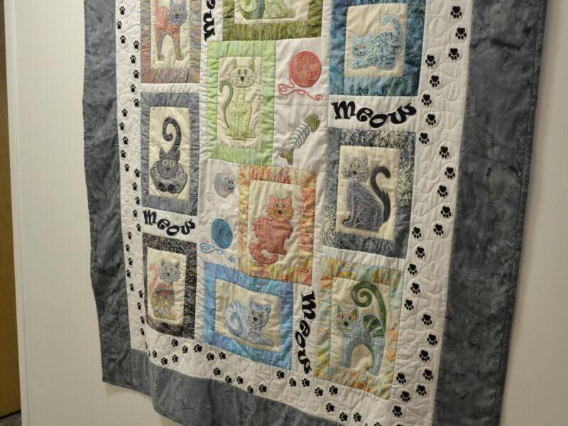 Beautiful handmade quilts greet you as you walk down the hallway.